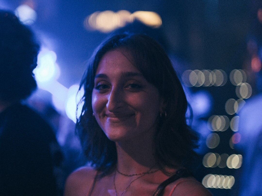 Elegant woman at a glamorous event with bright lights